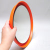 Miroir rond en métal orange circa 70